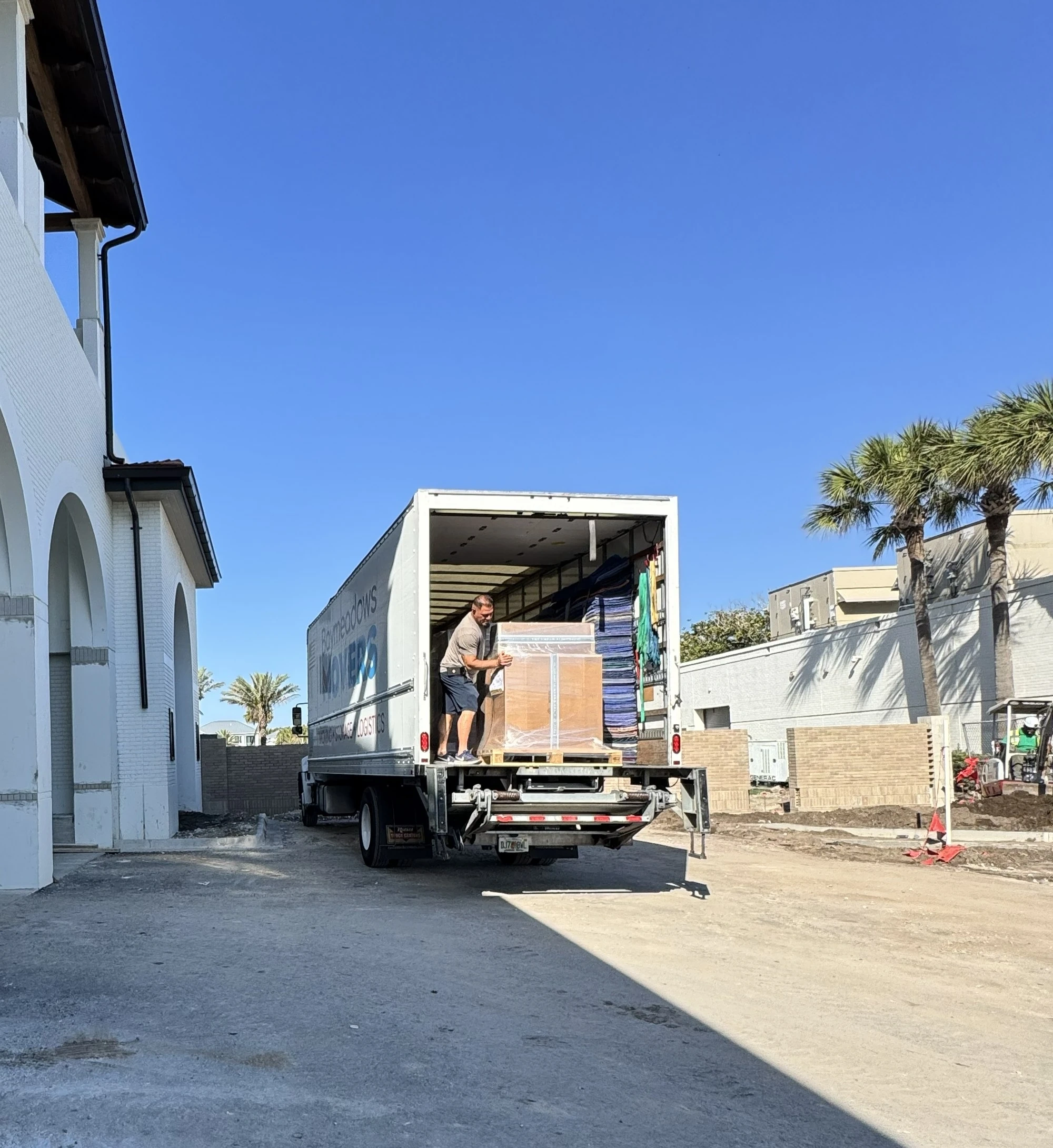 People delivering packages from a moving truck